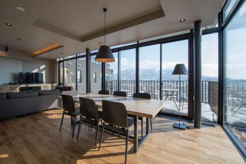 a kitchen and dining room with a table and chairs at Aspect Luxury Apartments by H2 Life in Kutchan