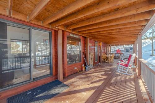 a porch of a wooden house with rocking chairs at Enjoy the Tiny Home Experience as the Perfect Basecamp to the Rockies! The Northstar Cabin in Fairplay