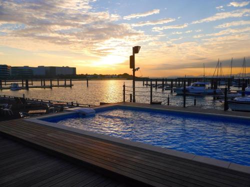 a large swimming pool next to a marina with boats at Osaka Hokko Marina HULL in Osaka