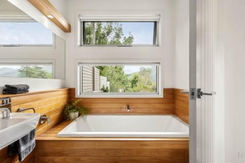 a bath tub in a bathroom with a window at Aalborg Bright in Bright