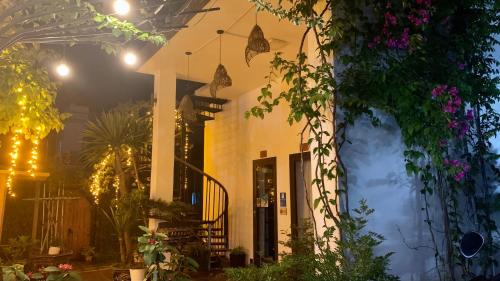 a building with plants and flowers on it at Coto Center Homestay in Dao Co To