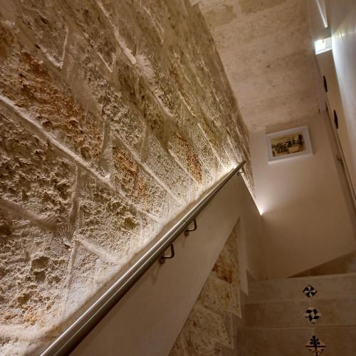 a stairway with a brick wall and a stair case at La Casetta in Mola di Bari