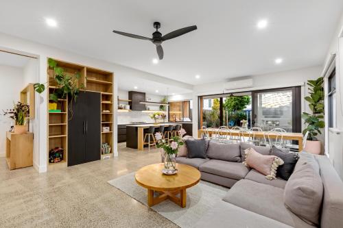 a living room with a couch and a table at Sensational 4 Bedroom House - Free Parking - Free WIFI in Ocean Grove