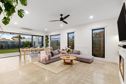 a living room with a couch and a table at Sensational 4 Bedroom House - Free Parking - Free WIFI in Ocean Grove
