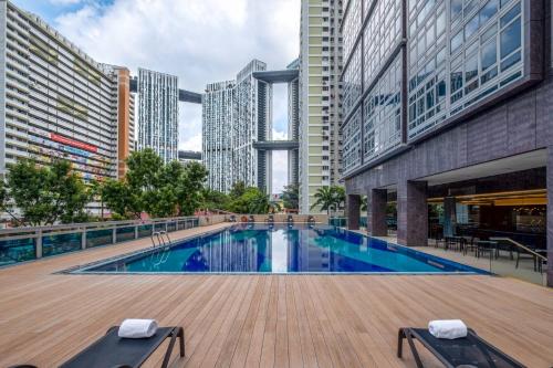 a swimming pool in a city with tall buildings at Orchid Hotel in Singapore