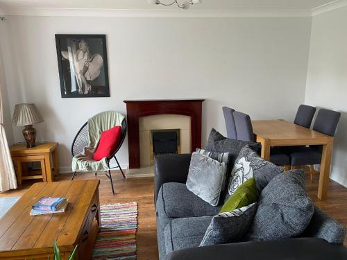 a living room with a couch and a table at ROOM ONLY - private property in quiet estate in Nottingham