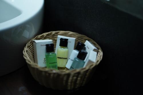 a basket full of soap andodorizers on a table at Gedara Villa in Kalutara