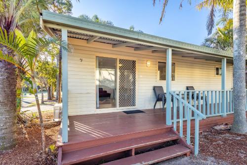 a porch of a house with a wooden deck at Ingenia Holidays One Mile Beach in One Mile