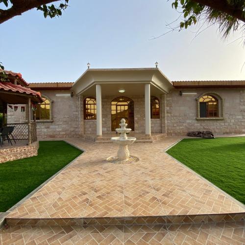 a fountain in the yard of a house at UAE farm in Qūr