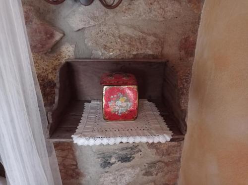 a red box is sitting on a stairs at Casa Rural El Fontano CR-CC-182 in Montánchez