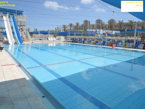 a large swimming pool on a cruise ship at Haifa Almog Tower- "Blue Reef" Suite On The Sea in Haifa