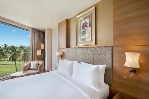 a hotel room with a large bed and a window at Radisson Salem in Salem