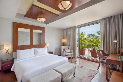 a bedroom with a large bed and a large window at Radisson Salem in Salem