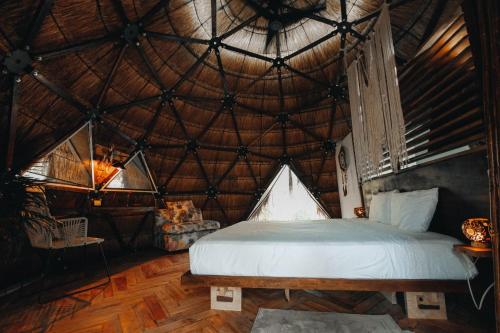 a bedroom with a bed in a round room at Ekumal by Villas Duendes Rotamundos in Akumal