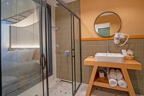 a bathroom with a shower and a sink and a mirror at Hotel Karbel Sun in Oludeniz