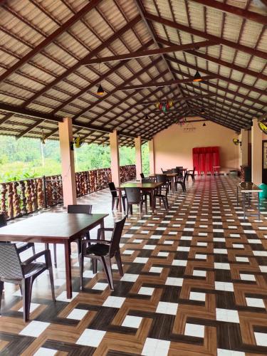 a restaurant with tables and chairs and a wooden floor at DELIGHTFUL HOMESTAY in Sollebail