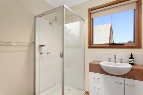 a bathroom with a shower and a sink at Magnolia in Apollo Bay