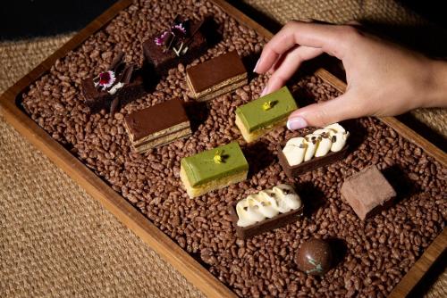 a person reaching for a box of chocolates at Mövenpick Hotel Auckland in Auckland