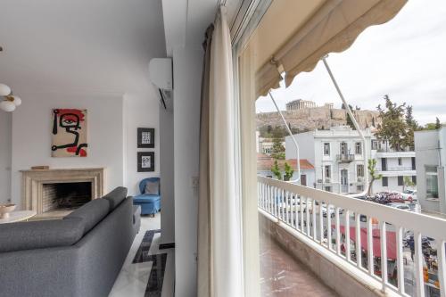 a living room with a couch and a balcony at Deco Marble Apt with Acropolis view in Athens