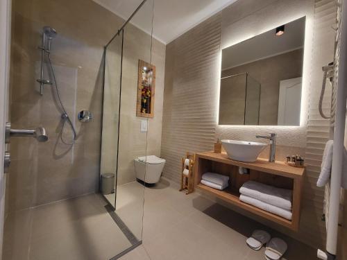 a bathroom with a sink and a toilet and a shower at Hotel Excellence in Bucharest