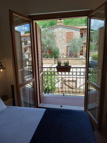 a bedroom with a door open to a balcony at I TRE POETI in Saturnia