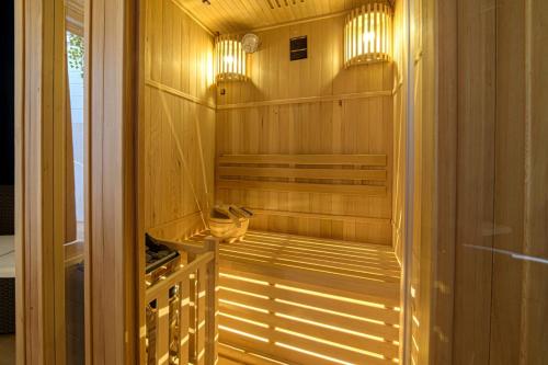 a sauna with wood paneling and lights in a room at Aminta - Rooms & Wellness in Andria