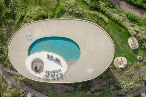 an overhead view of a circle with a blue lake at Sala Khaoyai in Wangkata
