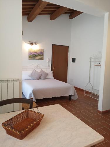 a hotel room with a bed and a table at I TRE POETI in Saturnia