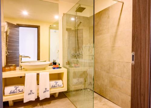a bathroom with a glass shower and a sink at VOI Andilana Beach Resort in Nosy Be