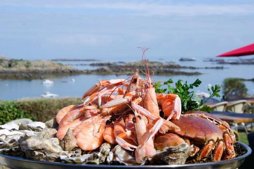 a large pile of shrimp in a bowl on a table at Longère rénovée avec accès direct à la mer in Guimaëc