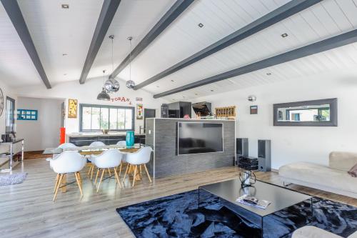a living room with a large television and a couch at Villa Lizelya in La Couarde-sur-Mer