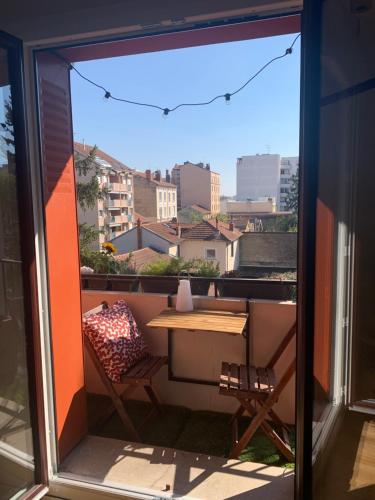 a view of a balcony with a table and a chair at Joli appartement près du métro in Villeurbanne