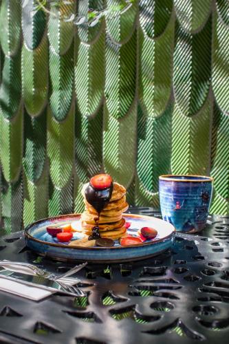 a plate of pancakes and fruit on a table at The Soul Istanbul Hotel in Istanbul