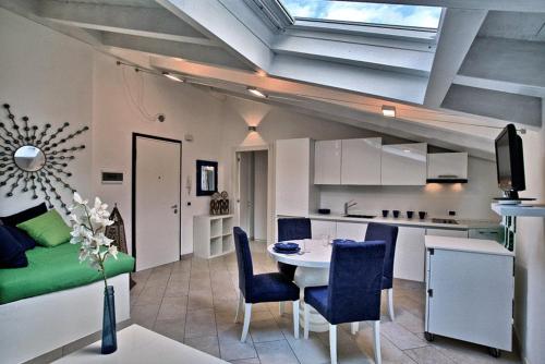 a kitchen and a living room with a table and chairs at Villa Maggie on Lake Como in Malgrate