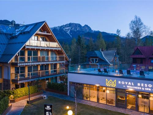 a view of a hotel with mountains in the background at VisitZakopane - Royal Resort Wellness & SPA in Zakopane
