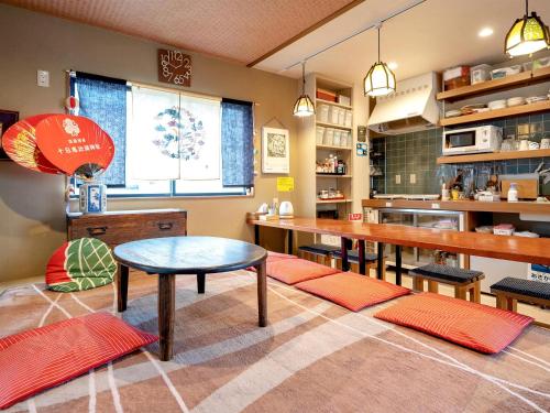 a dining room with a table and a tableasteryasteryasteryasteryasteryasteryastery at Guest House Nakaima in Fukuoka