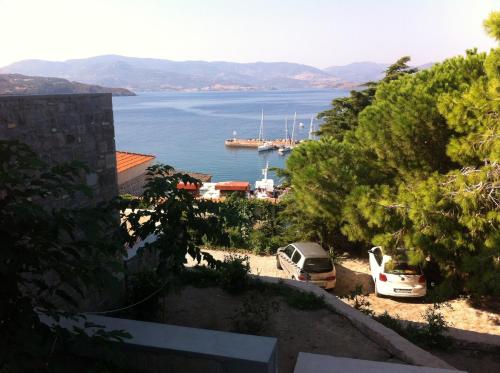a view of a body of water with cars parked at Heliades Maisonettes in Mithymna