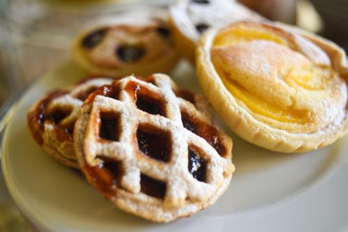 a plate with two waffles with syrup at Maria's B&B in Għasri