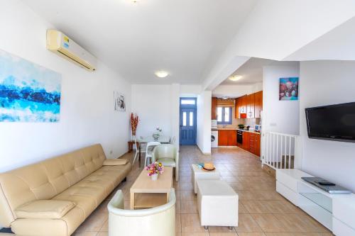 a living room with a couch and a table at Villa Nora in Protaras