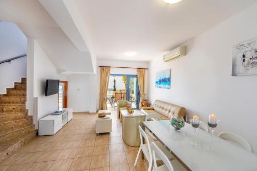 a living room with a couch and a table at Villa Nora in Protaras