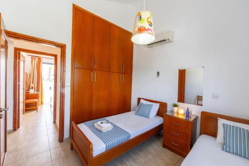 a small bedroom with a bed and a cabinet at Villa Nora in Protaras
