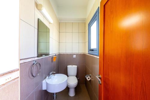 a bathroom with a toilet and a sink at Villa Nora in Protaras
