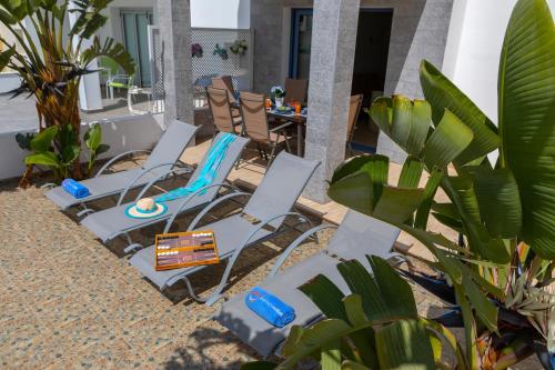 a group of chairs and a table on a patio at Villa Nora in Protaras