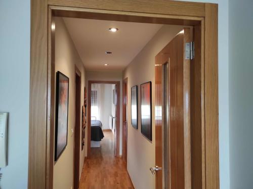 a hallway with paintings on the walls of a house at Piso en primera linea de Playa en Laxe in Laxe