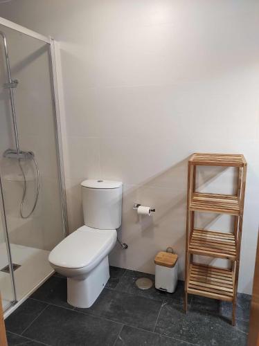 a bathroom with a toilet and a shower at Piso en primera linea de Playa en Laxe in Laxe