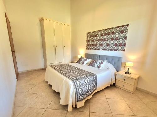 a bedroom with a bed and a dresser and a bed sidx sidx sidx sidx at Saludi&Trigu - Rural Apartments in Iglesias