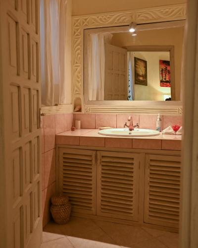 a bathroom with a sink and a mirror at Lions' Luxury Eco Resort & Spa in Malindi