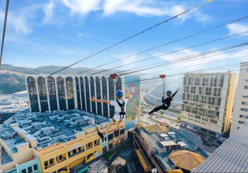 two people jumping on the edge of a building at Maison L'OCCITANE in Macau