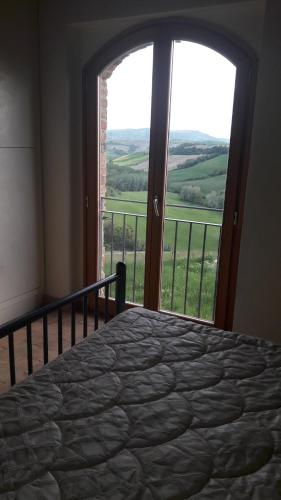 Un pat sau paturi într-o cameră la Podere La Villa