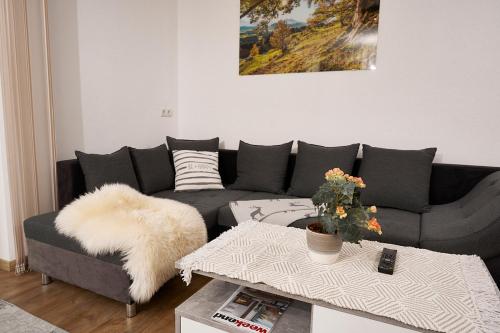 a living room with a couch and a table at Apart Schranz in Umhausen